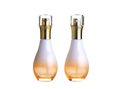 white and orange glass spray bottle